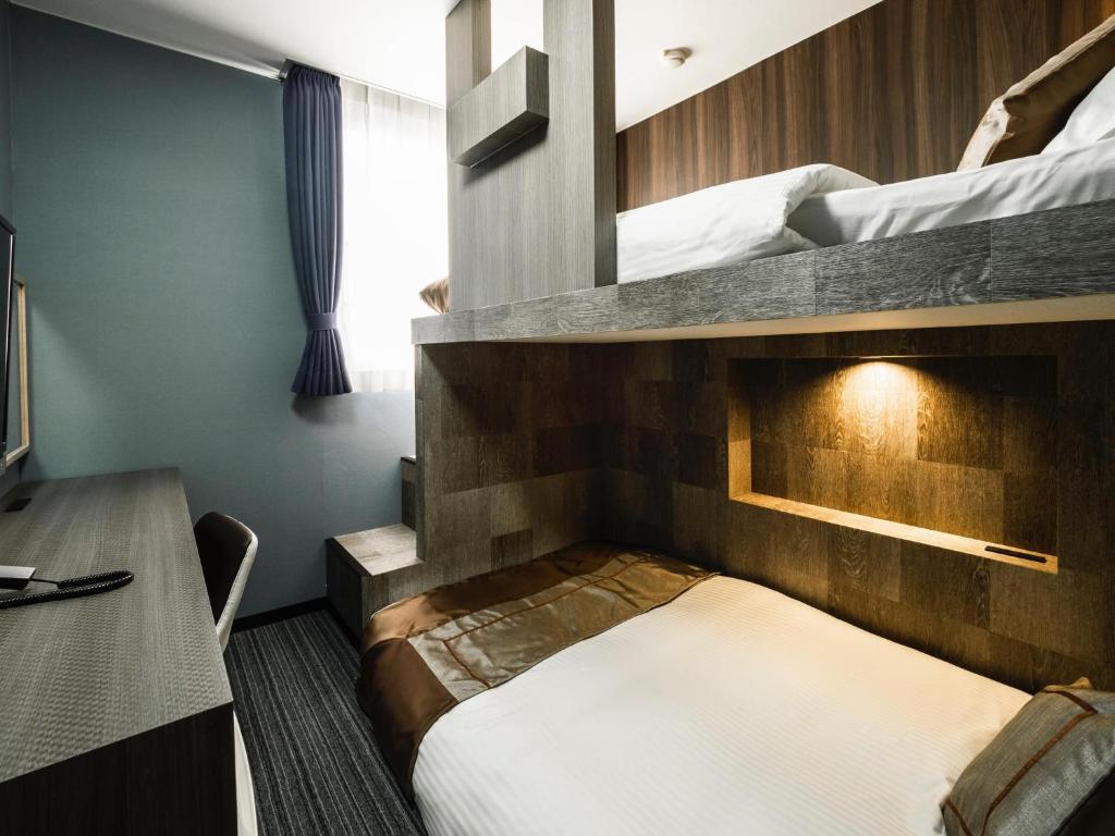 Postel nebo postele na pokoji v ubytování Hotel Areaone Kitaibaraki