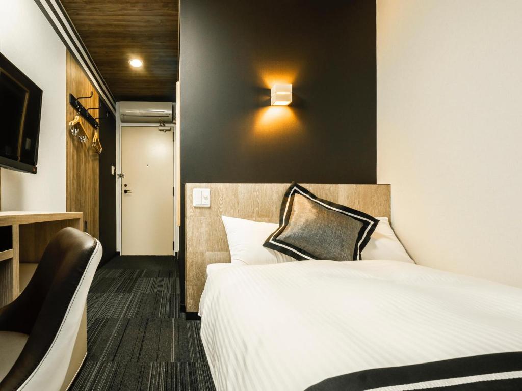 Postel nebo postele na pokoji v ubytování Hotel Areaone Kitaibaraki