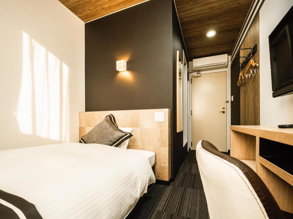 Postel nebo postele na pokoji v ubytování Hotel Areaone Kitaibaraki