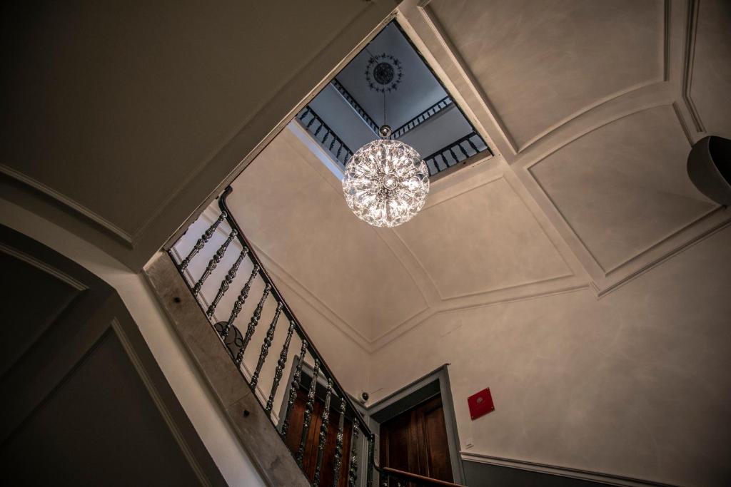a chandelier hanging from the ceiling of a staircase at Corte dei medici - Palace in Catania