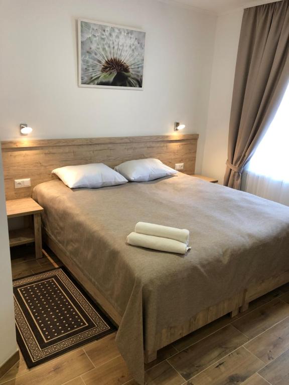 ein Schlafzimmer mit einem Bett mit zwei Handtüchern darauf in der Unterkunft Hotel Bonus in Kolomyja