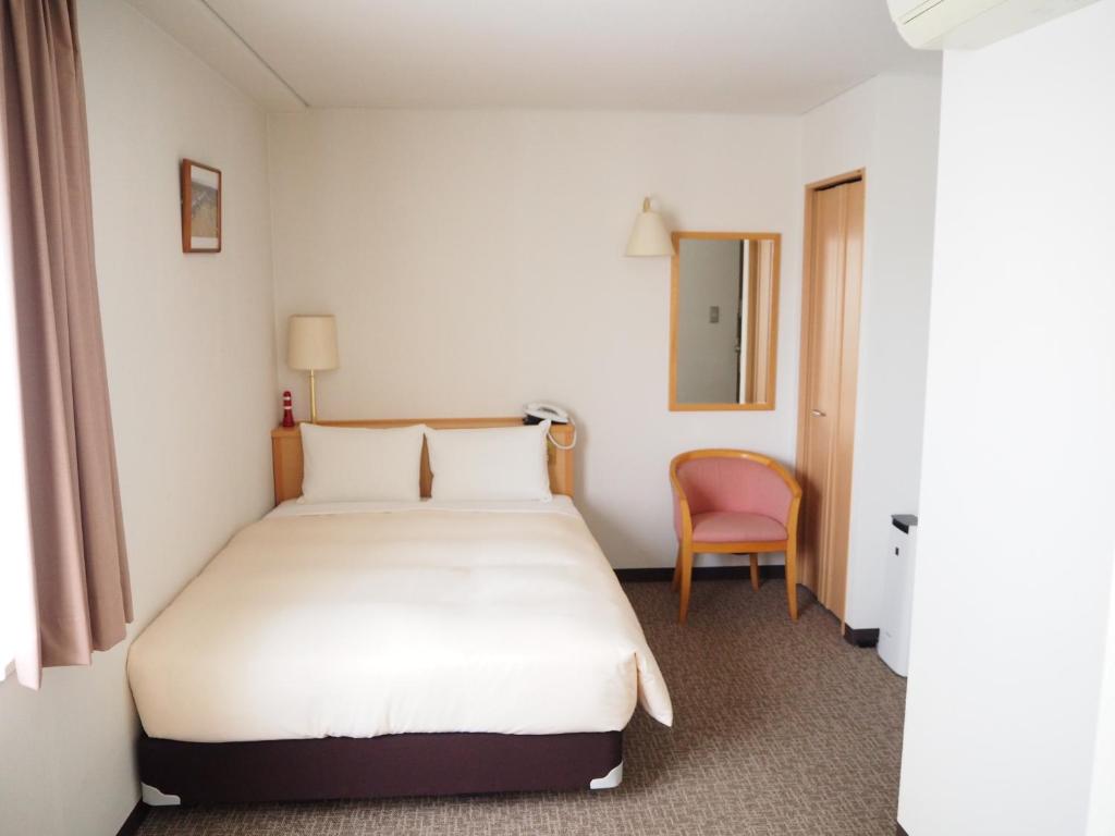 Postel nebo postele na pokoji v ubytování Hotel Route Tsukuba