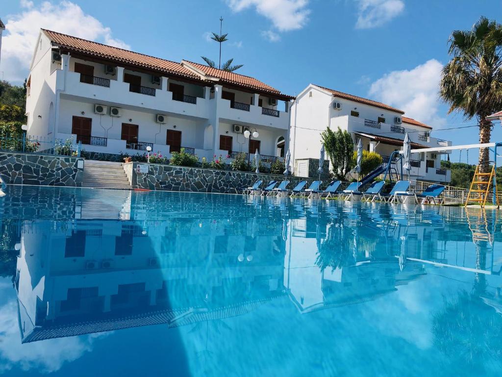 a large swimming pool in front of a hotel at Tria Adelphia in Arillas