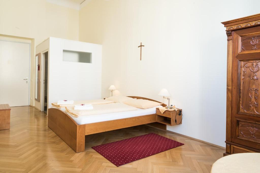 Postel nebo postele na pokoji v ubytování Gästehaus im Priesterseminar Salzburg