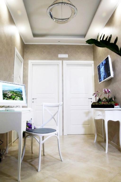 Televízia a/alebo spoločenská miestnosť v ubytovaní B&B Pompei Olympus