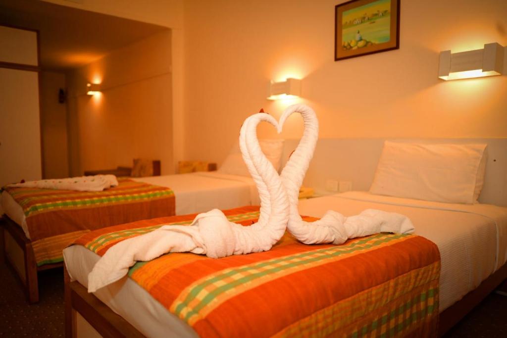 Postel nebo postele na pokoji v ubytování Cleopatra Hotel