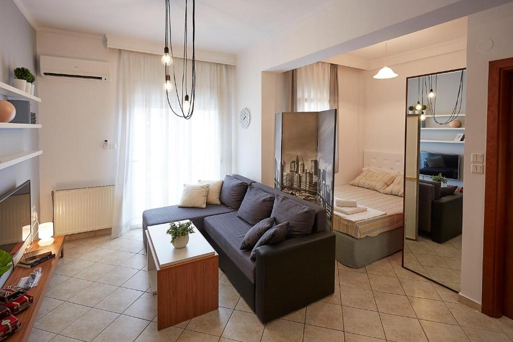 a living room with a couch and a bedroom at LUXURY STUDIO in Xanthi in Xanthi