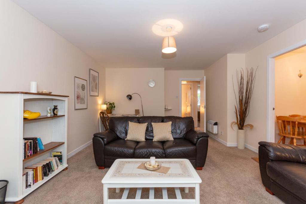 
a living room filled with furniture and a fireplace at Central St Andrews 2 Bed Apartment - Free Parking in St. Andrews
