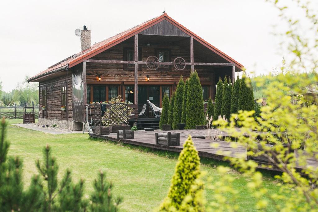 a log cabin with a bench in front of it at Gasan Place - Domki na Mazurach in Pisz