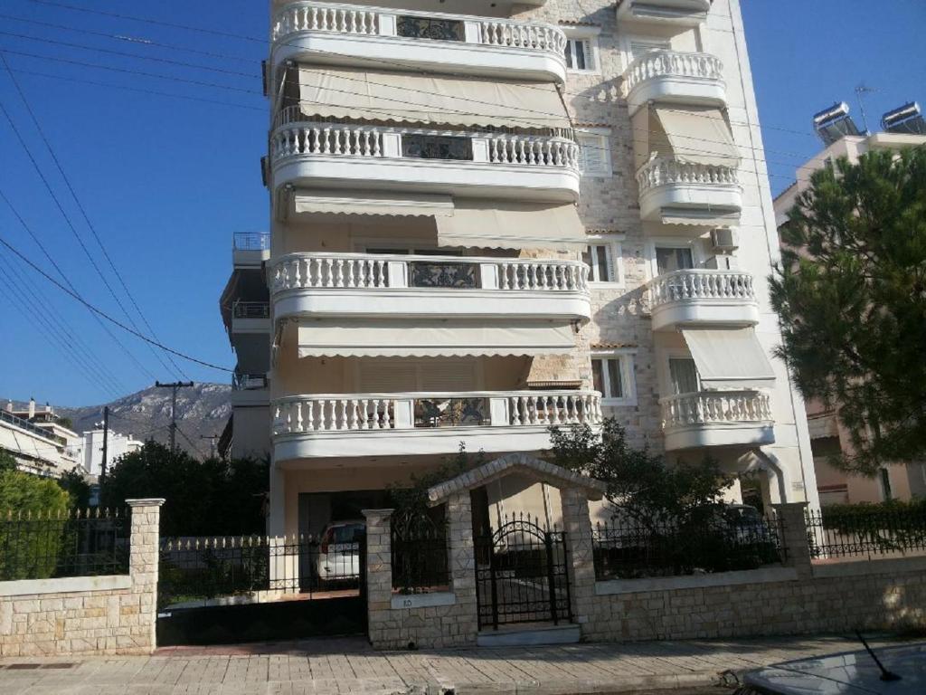 a tall white building with balconies on it at Luxury Apartment in Ano Glyfada in Athens