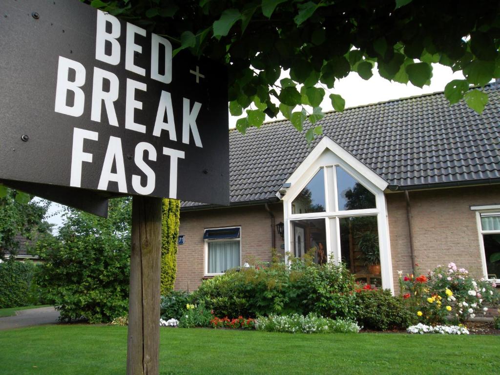 a bed break fast sign in front of a house at Hof van Lutten in Lutten