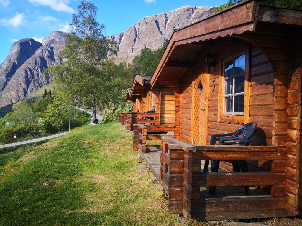 a cabin in the mountains with mountains in the background at Winjum Cabin Aurland Stegastein in Aurland