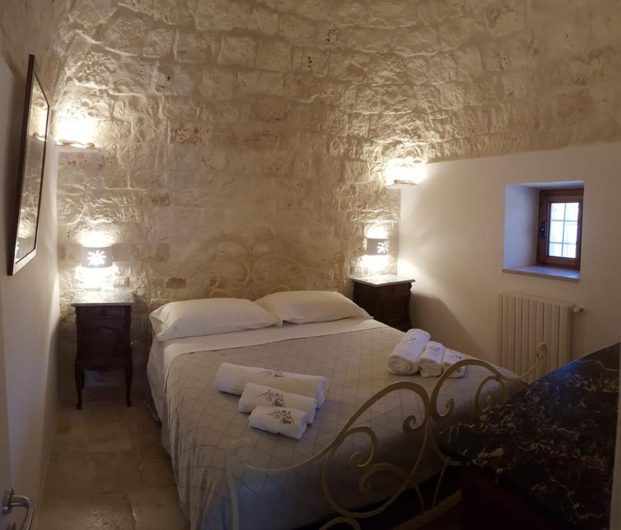 Łóżko lub łóżka w pokoju w obiekcie TRULLI ASIA