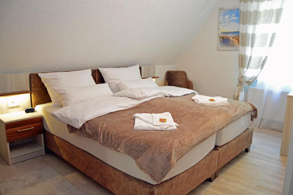 a bedroom with a bed with two towels on it at Ambiente in Soltau