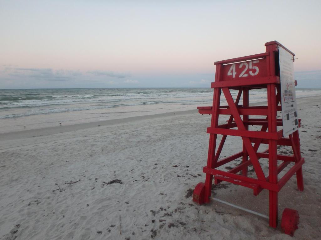 a lifeguard stand on a beach with the ocean at Honu Hideaway at Ocean Walk Resort in New Smyrna Beach