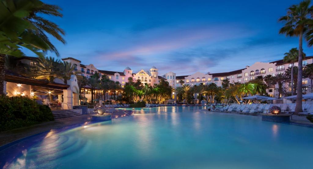 a large swimming pool in a resort at night at Universal's Hard Rock Hotel® in Orlando