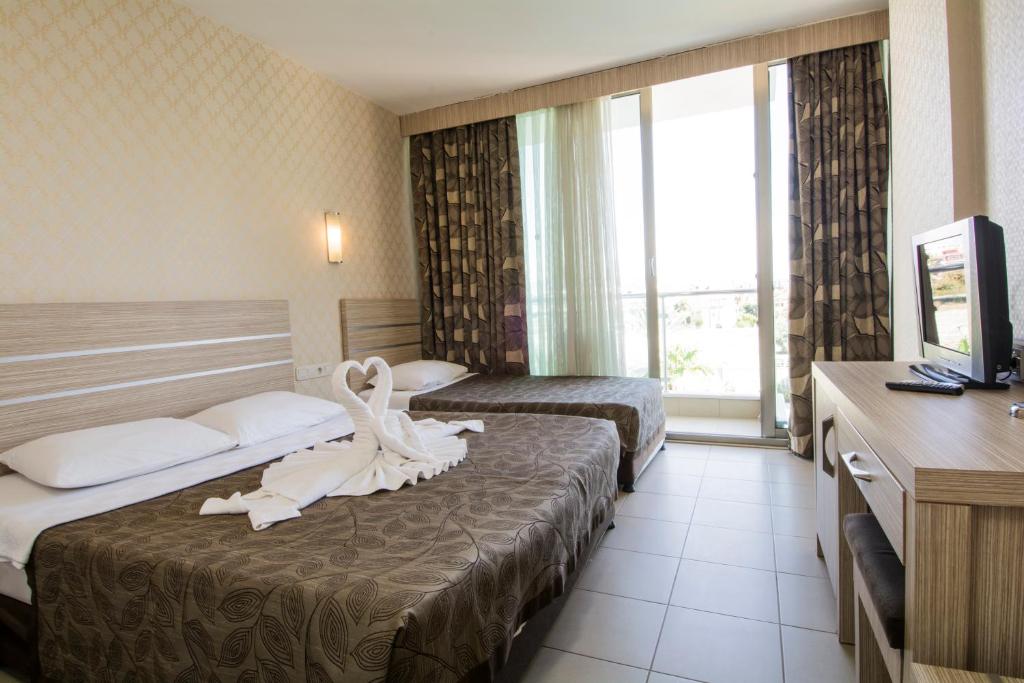 Postel nebo postele na pokoji v ubytování Side Löwe Hotel