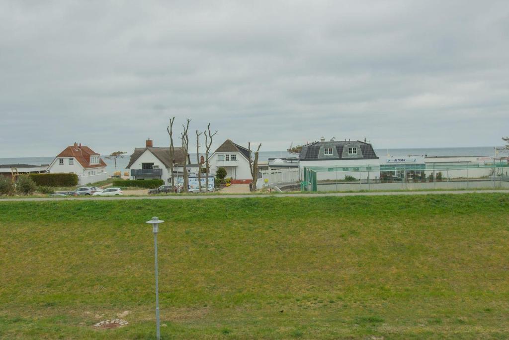 a row of houses with the ocean in the background at Haus am Deich Wohnung 9 in Dahme