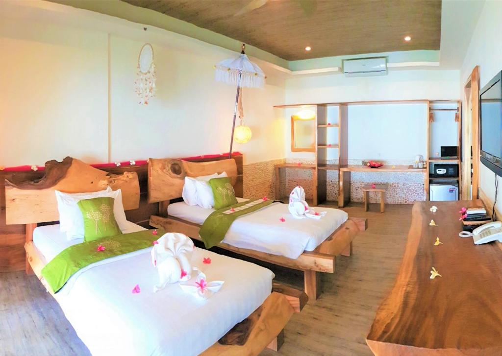 Postel nebo postele na pokoji v ubytování Samba Villas Beachfront View