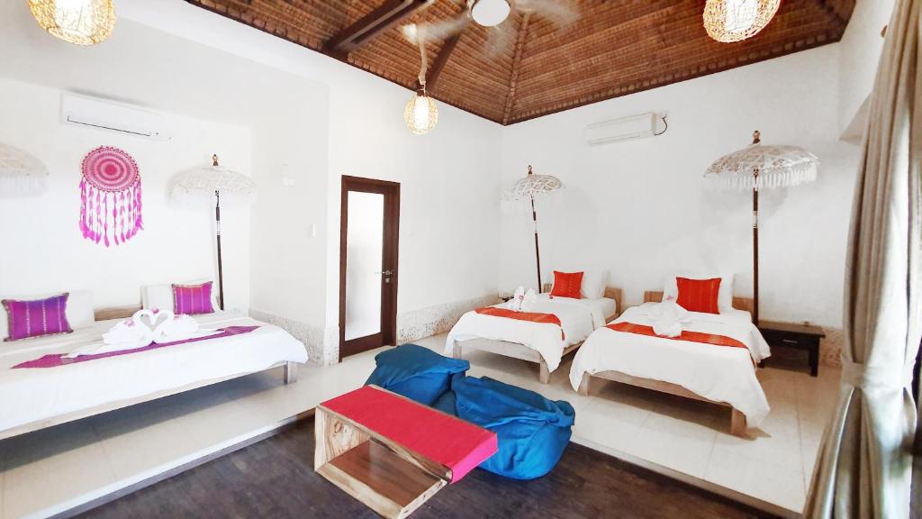 Postel nebo postele na pokoji v ubytování Samba Villas Beachfront View