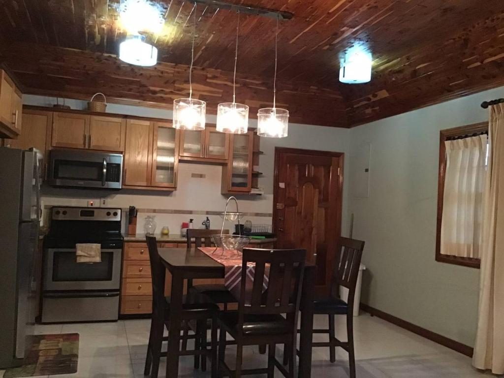 a kitchen with a table and chairs in a room at 12 Fairway Avenue in Kingston
