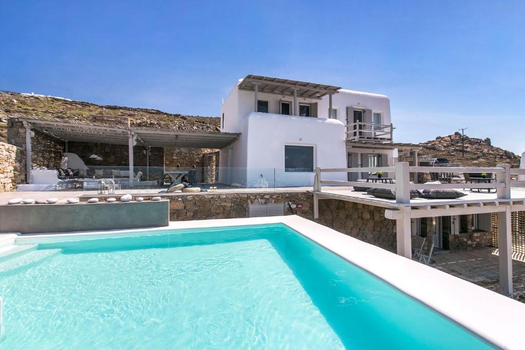 a swimming pool in front of a villa at Villa Tonic by Mykonos Mood in Agios Ioannis Mykonos