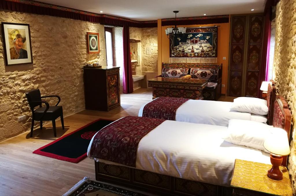 a hotel room with two beds and a desk at Himalaya en Perigord in Tursac