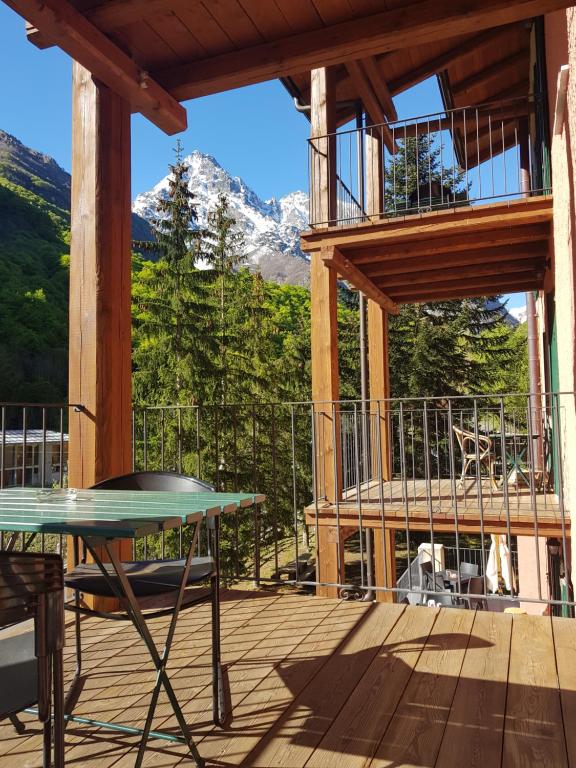 a table on a deck with a view of a mountain at La Casaregina in Valdieri