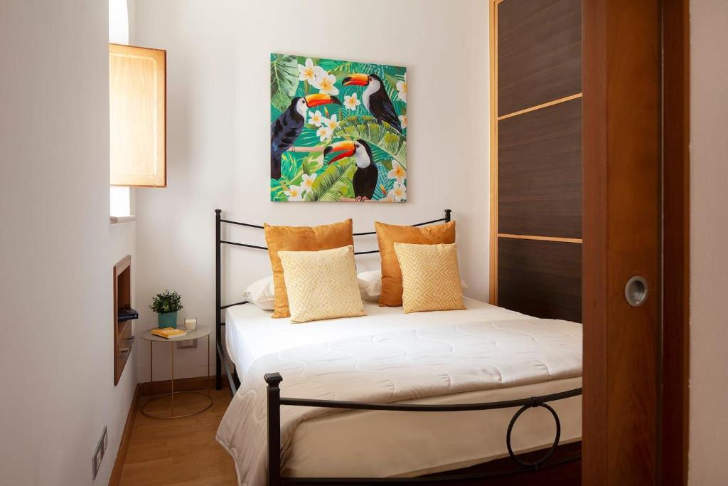 a bedroom with a bed and a painting on the wall at 44 Steps - Enjoy Noto in Noto