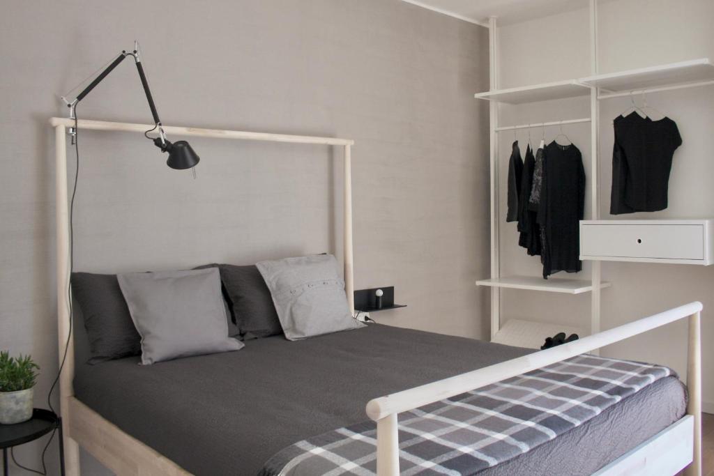 a bedroom with a bed with a white headboard at Fortuna's quiet place in Riva del Garda