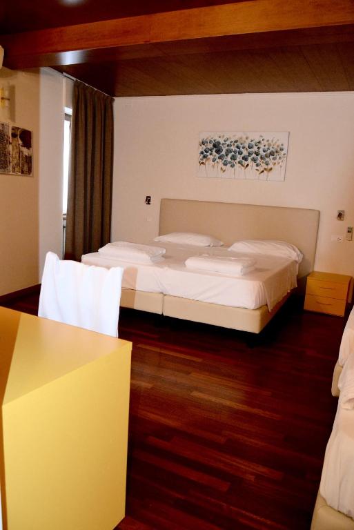 Postel nebo postele na pokoji v ubytování Hotel Pinamonte