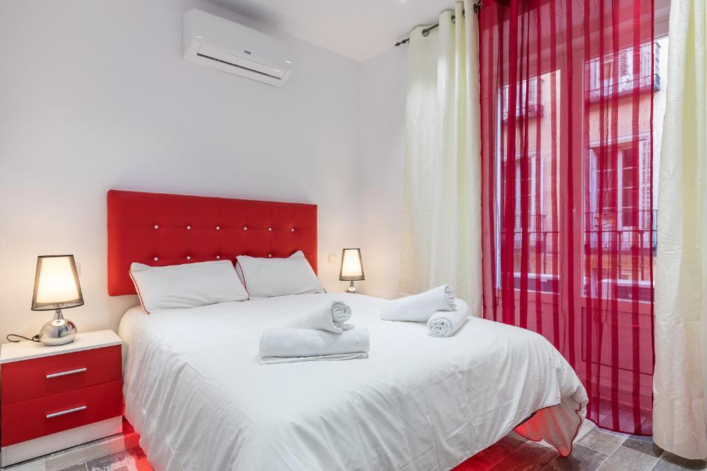 a bedroom with a large bed with two towels on it at Calle de Felipe III, 7 in Madrid