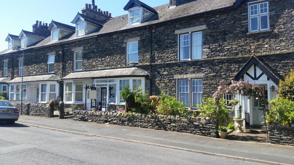 a row of houses on the side of a street at Montfort Cottage Guest House in Windermere