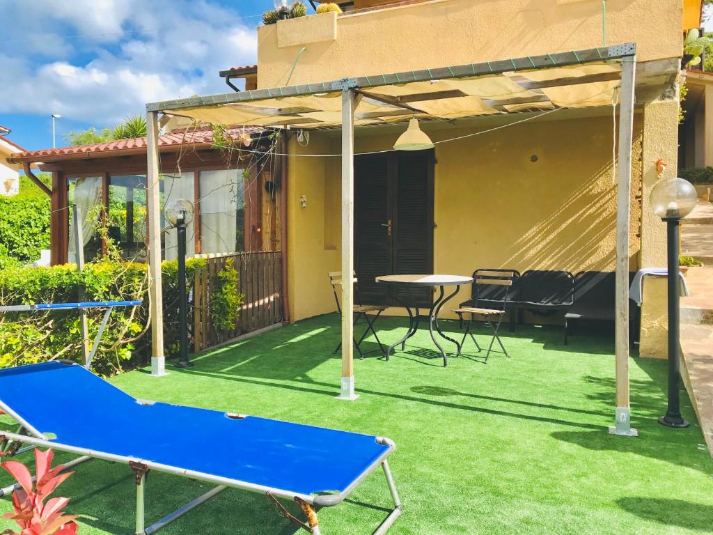 a patio with a ping pong table and awning at Monolocale Via Panoramica in Rio Marina