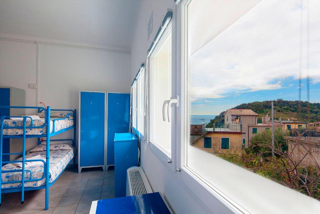 a balcony with bunk beds in a room with a window at Ostello Corniglia in Corniglia