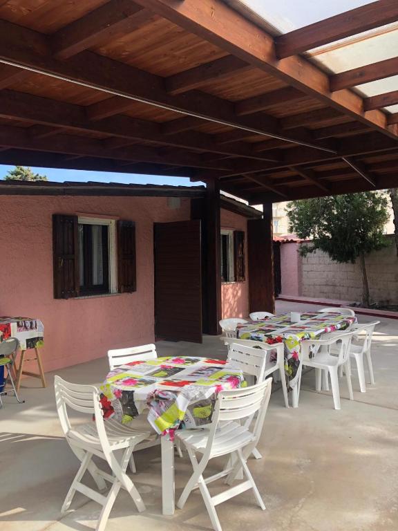 a group of tables and chairs on a patio at Fleming 46 in Alghero