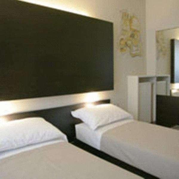 Postel nebo postele na pokoji v ubytování Art Hotel Udine