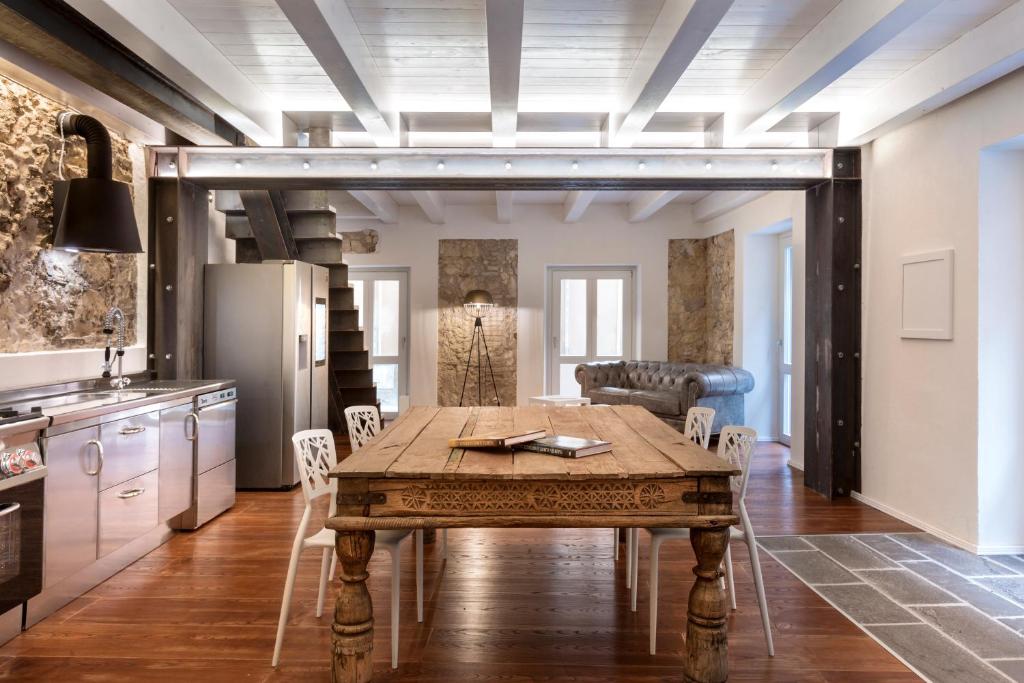 a kitchen with a wooden table in a room at Cagliari Marina Harbour Guest house & Lounge in Cagliari