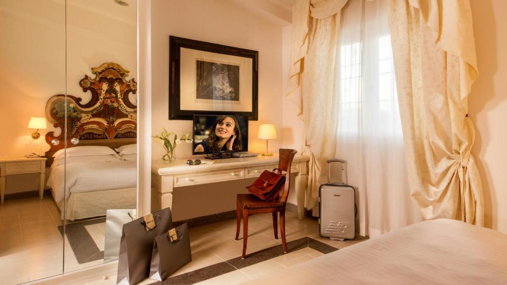 Postel nebo postele na pokoji v ubytování Arcom Palace