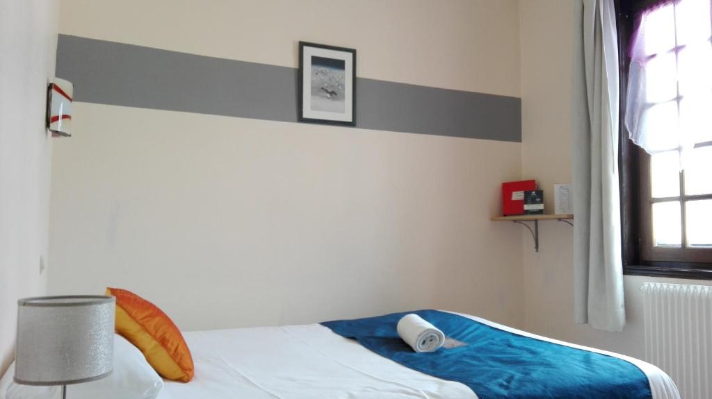 Postel nebo postele na pokoji v ubytování Hôtel Le Chantilly