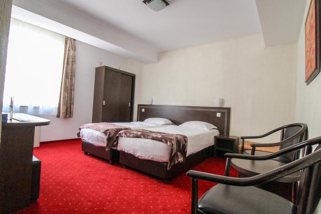 Postel nebo postele na pokoji v ubytování Hotel Razvan