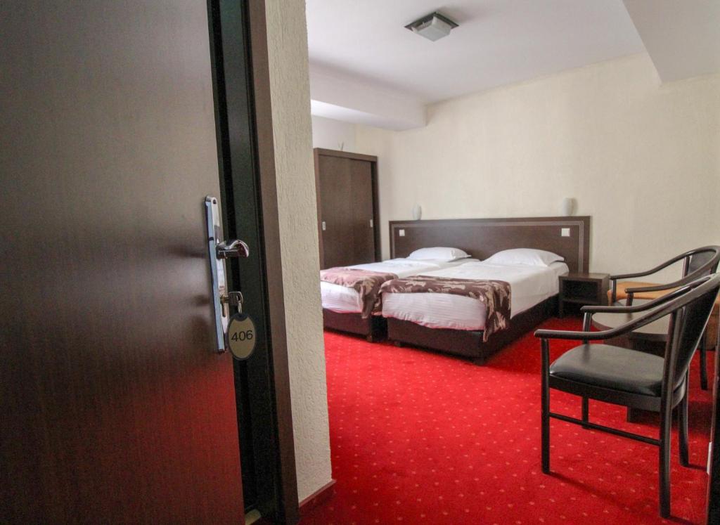 Postel nebo postele na pokoji v ubytování Hotel Razvan
