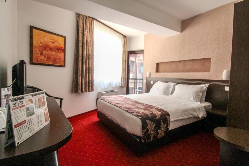 Postel nebo postele na pokoji v ubytování Hotel Razvan