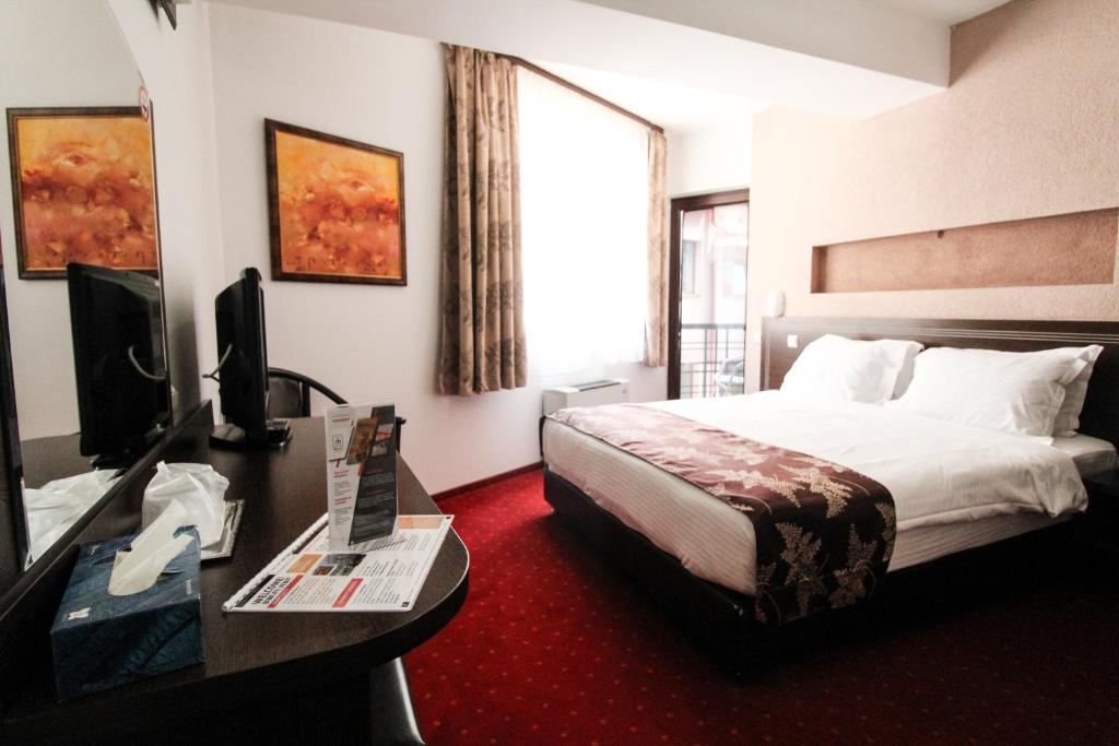 Postel nebo postele na pokoji v ubytování Hotel Razvan