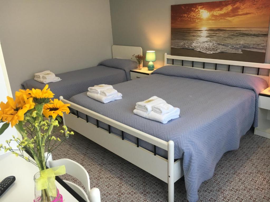 Postel nebo postele na pokoji v ubytování Hotel Gianna