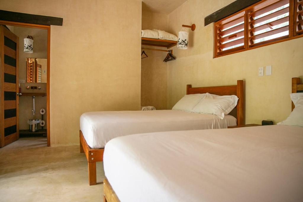 Postel nebo postele na pokoji v ubytování Hotel Buenavista Bacalar Jungle Experience