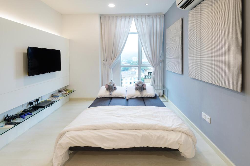 Postel nebo postele na pokoji v ubytování Straits Garden Suites, Georgetown