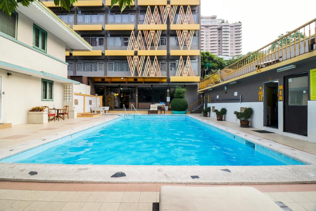 a swimming pool in front of a building at Malaysia Hotel Bangkok in Bangkok