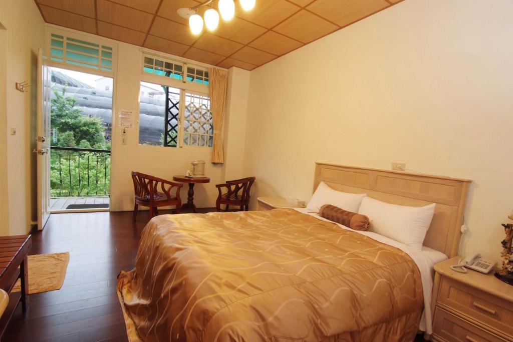 a bedroom with a bed with a dog laying on it at Cing Jing Homeland Resort Villa in Ren&#39;ai