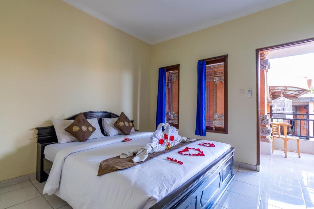 Postel nebo postele na pokoji v ubytování Kacu Ubud Inn